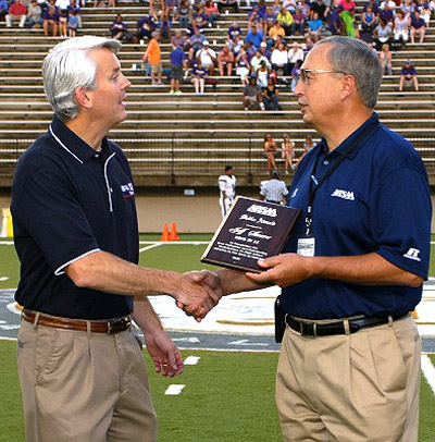The 2011 AHSAA Media Award is presented to Jeff Shearer (left) of WSFA-TV by Executive Director Steve Savarese prior to the opening game of the 2011 Championship Challenge. (Photo special to AHSAA)