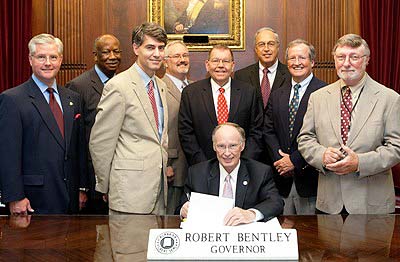 AHSAA's Steve Savarese (back right) and Joe Evans (back left) at the signing ceremonies for the new State Concussion Law. (Photo special to AHSAA)