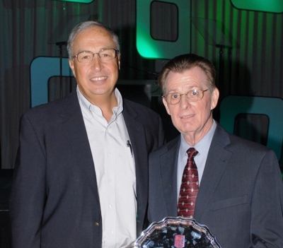 AHSAA Executive Director Steve Savarese (left) congratulates Assistant Director Alan Mitchell, who received a NFHS Citation Award for his contributions to the AHSAA. (Photo special to AHSAA)