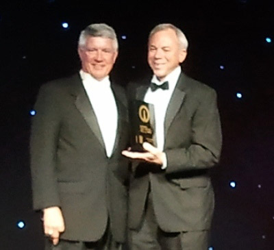 Pat Sullivan (right), inducted into the National High School Hall of Fame, is congratulated by NFHS Board President Rick Wulkow of Iowa during the induction ceremony in July 2012. (Photo special to AHSAA)