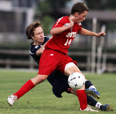 South's Evan Shavers (14) of Prattville gets the inside on Benson Mulvaney of Briarwood in boys soccer action. (Photo courtesy creative fx)